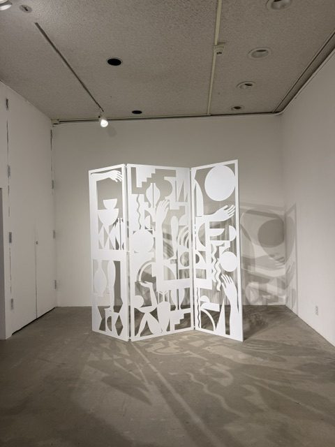IMAGE_1 Heavy Metal exhibition installation featuring a white cut-metal sculptural screen casting intricate shadows at LAMAG in Barnsdall Art Park.