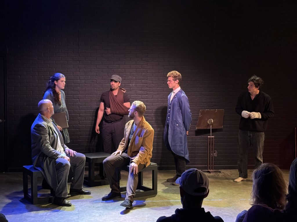 Cast members perform a dramatic scene in We Are All Burning at the 2026 Hollywood Fringe Festival.