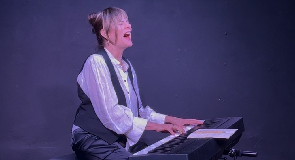 Tracey Yarad sings at the piano during All These Pretty Things, her acclaimed one-woman musical at the 2026 Hollywood Fringe Festival.