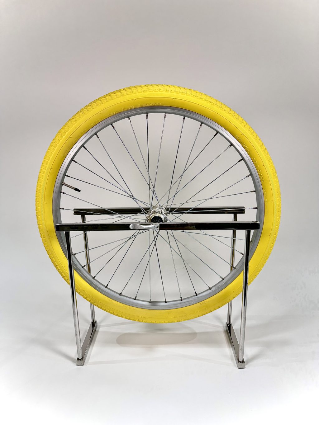 Point Circle #2 by Joseph Osborne Schoenleber, a contemporary sculpture combining a bright yellow bicycle tire, metal wheel and stainless steel frame.