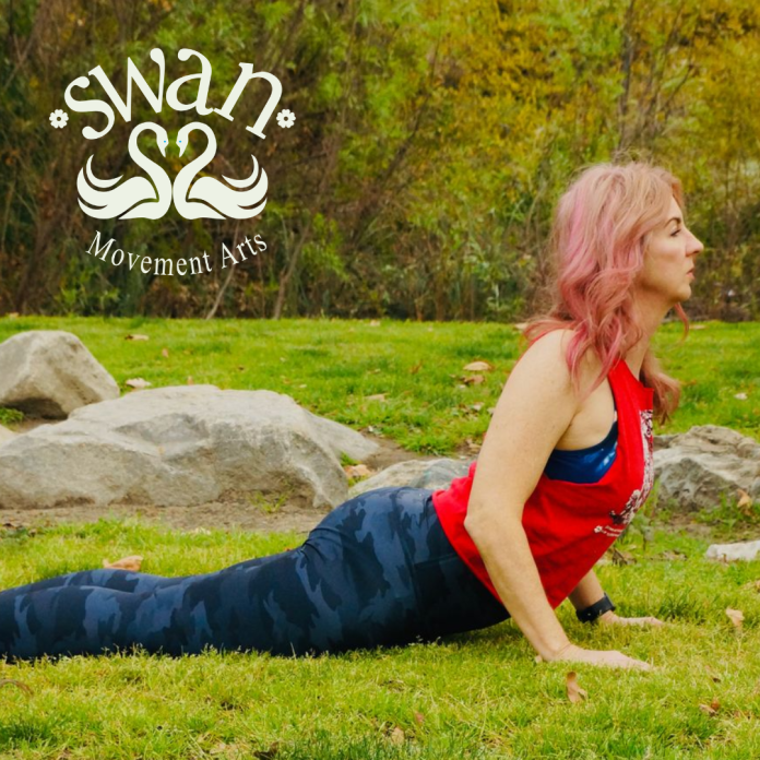 Swan performing an upward-facing yoga stretch outdoors with the Swan Movement Arts logo, highlighting yoga and wellness in North Hollywood.