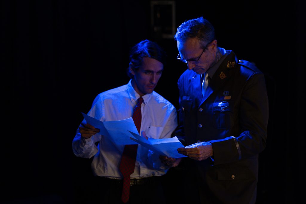 Characters examine evidence during a sci-fi mystery in A Haunting Revue II