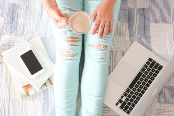 image Person shopping online with a laptop and coffee at home
