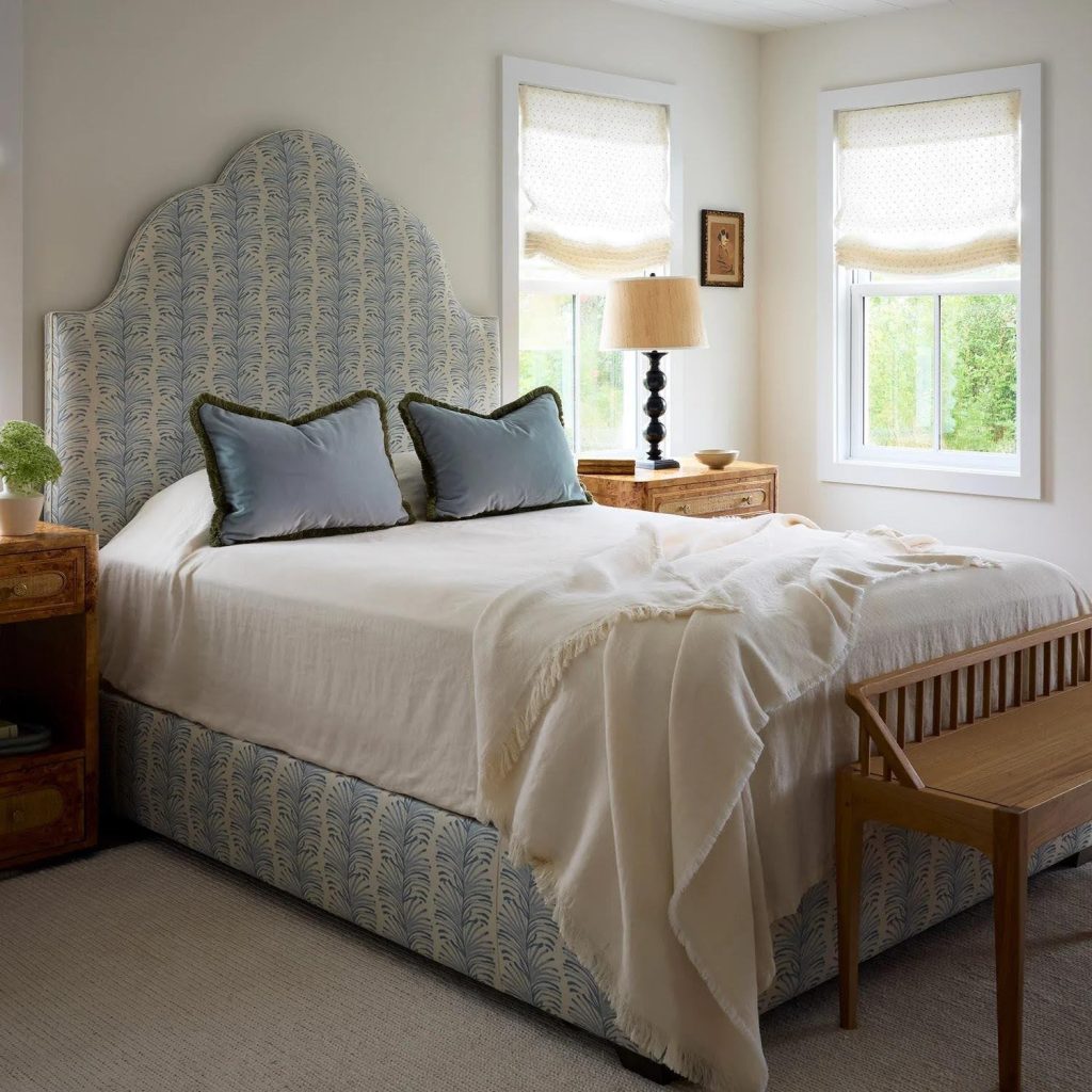 Bright modern bedroom with upholstered headboard wooden nightstands and natural light