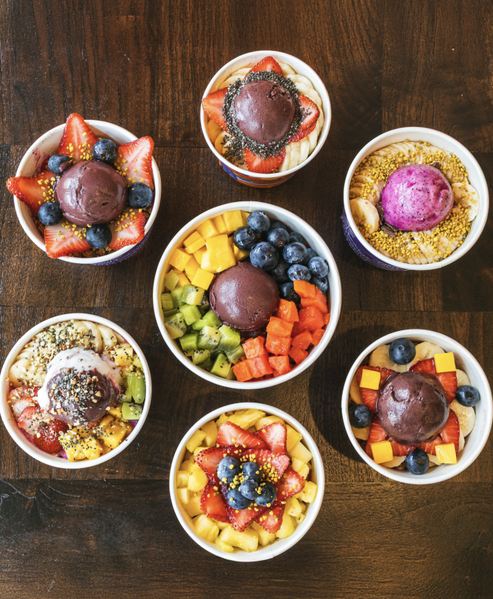 Assortment of authentic Brazilian açaí bowls topped with fresh fruit and granola.