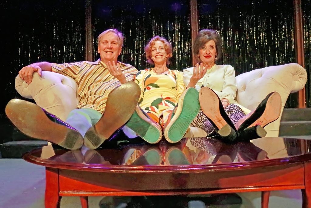 Three actors on a couch of The Group Rep's Applause