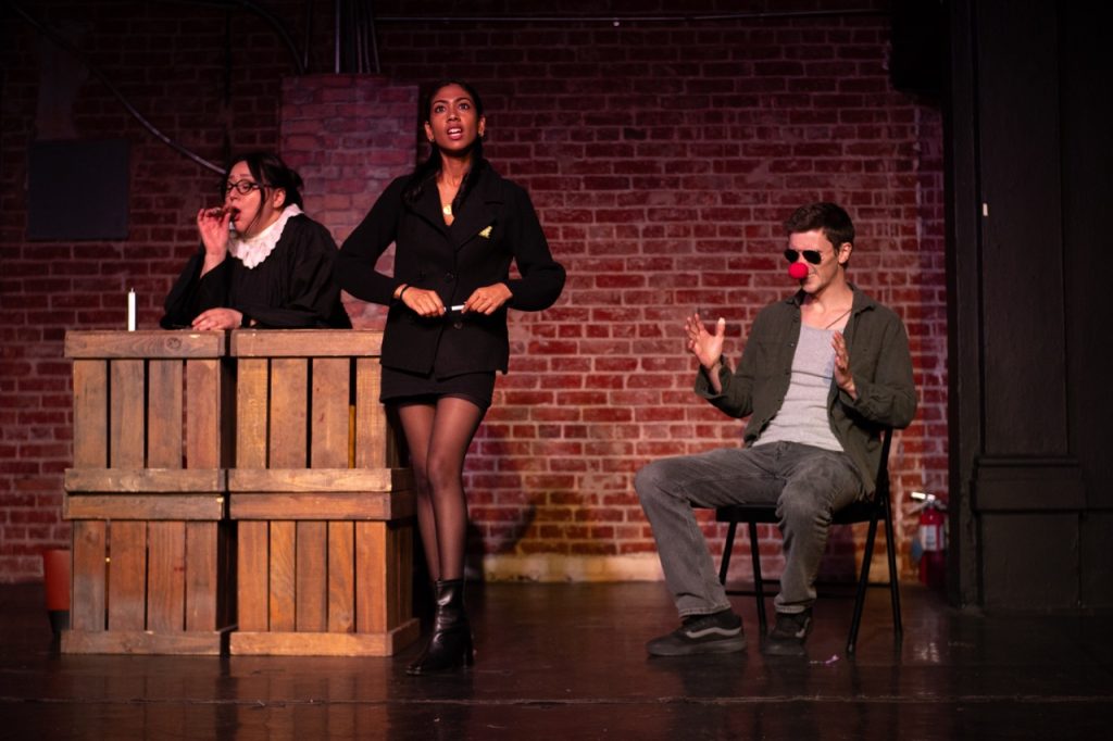 Courtroom scene from Case Closed?? featuring the judge, prosecutor, and a clown witness during the Hollywood Fringe Festival comedy.