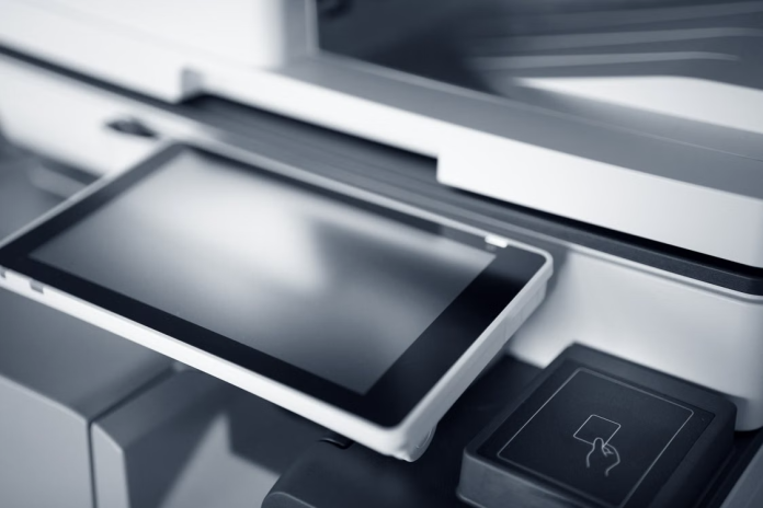 image Tablet connected to a digital fax system beside a multifunction printer, illustrating secure document management for independent film productions.