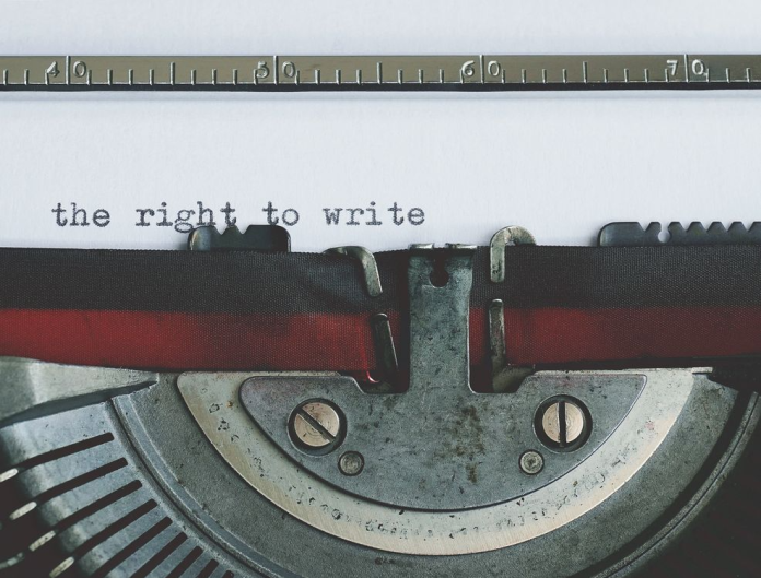 Typewriter printing a script, representing how to copyright a script and protect original creative work.