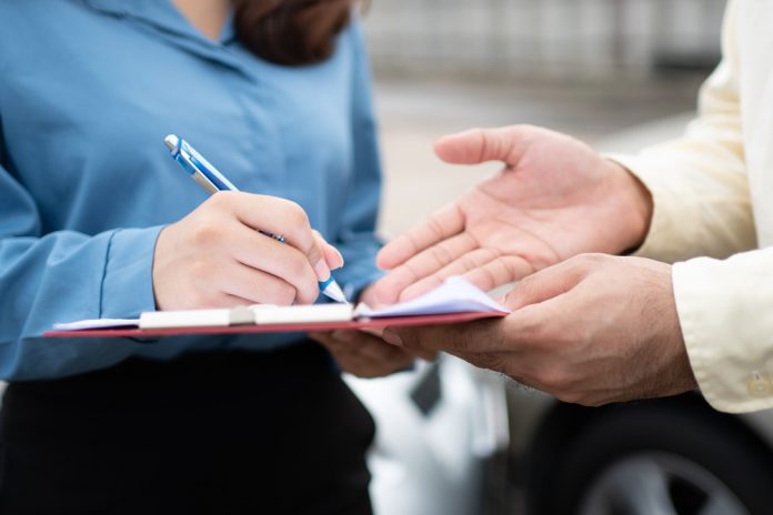 image Person signing legal paperwork while an attorney explains documents during a consultation about a motorcycle accident claim.