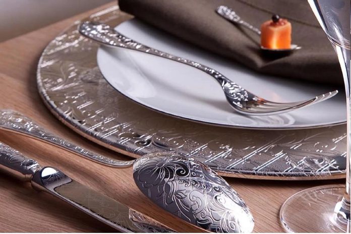image Elegant place setting featuring luxury flatware, floral porcelain plates, crystal glassware, and linen napkins on a beautifully styled dining table