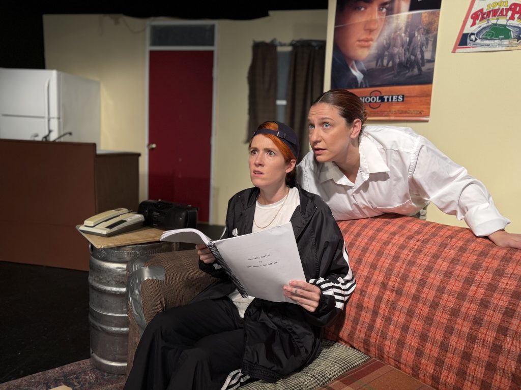 Genevieve Lerner and Spring Ferrara, as Matt Damon and Ben Affleck, stare in shock at a computer in a comedic scene from Matt & Ben at The Sherry Theater.