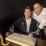 Genevieve Lerner and Spring Ferrara remain frozen in disbelief at a computer during a humorous moment in Matt & Ben at The Sherry Theater.