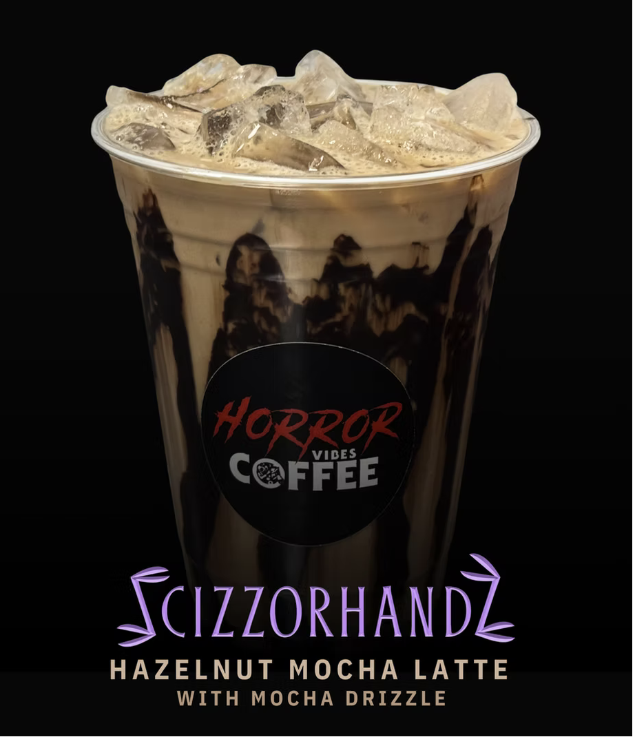 Horror Vibes Coffee Scizzorhandz hazelnut mocha latte with mocha drizzle over ice.