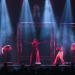 MARVELous: A Risqué Parody cast performing under dramatic red and blue stage lighting at El Portal Theatre.