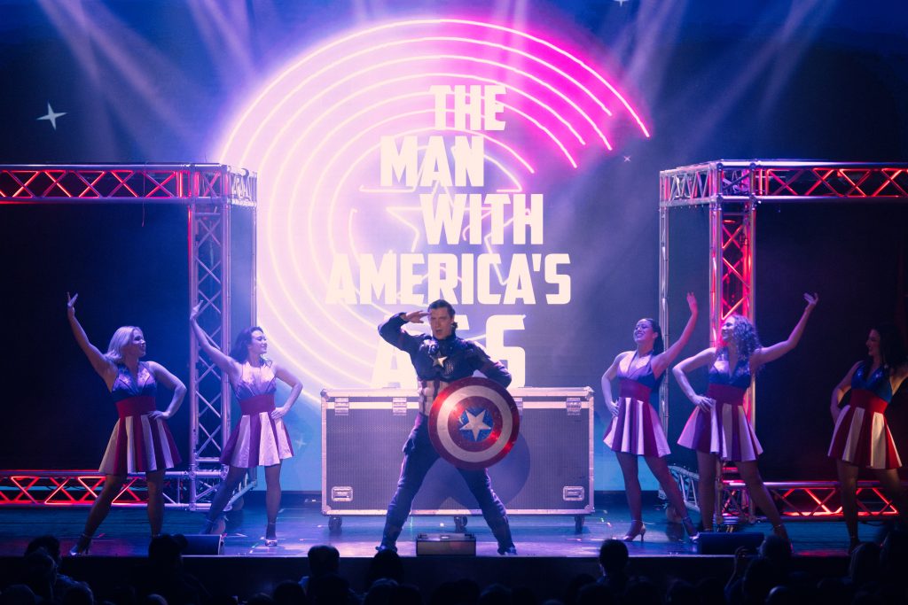 Captain America parody character performing with dancers during MARVELous: A Risqué Parody at El Portal Theatre.