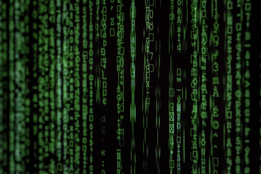 Computer screen displaying green digital code representing VPS security and data protection.