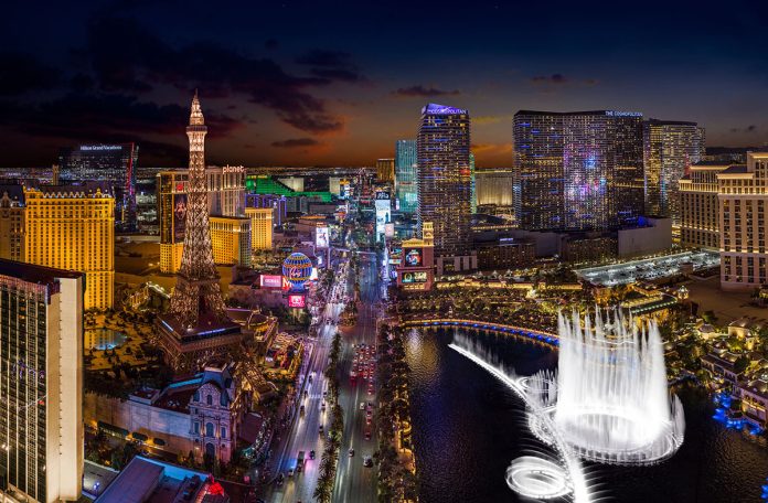 image Las Vegas Strip at night with illuminated hotels, casinos and the Bellagio fountains.
