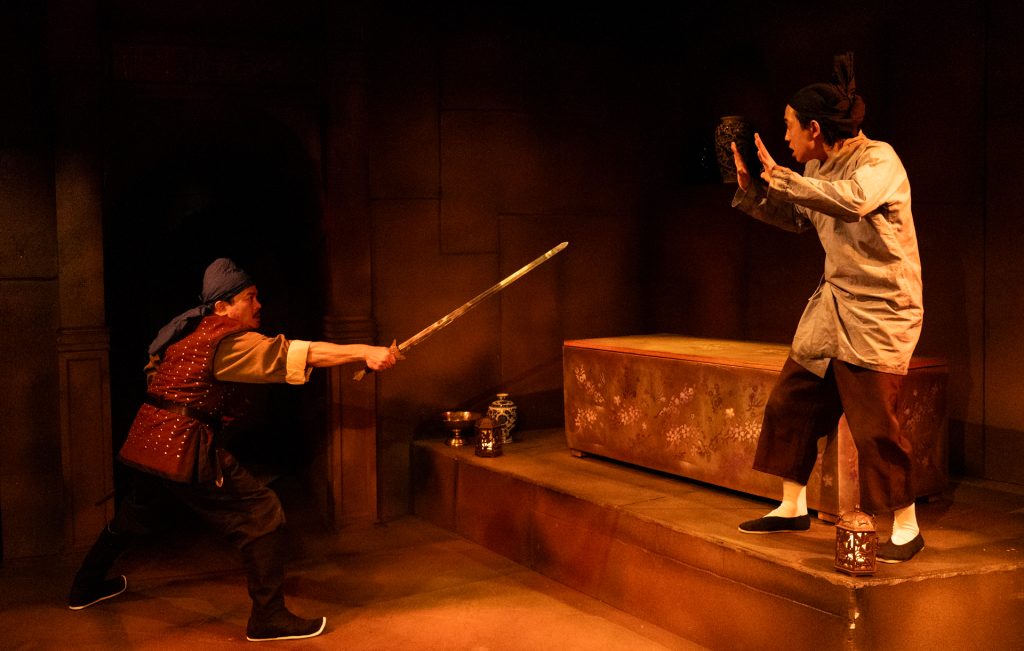 Alt text: Sword confrontation inside the emperor’s tomb in In the Tomb of Ten Thousand Calendars at Moving Arts Theatre.