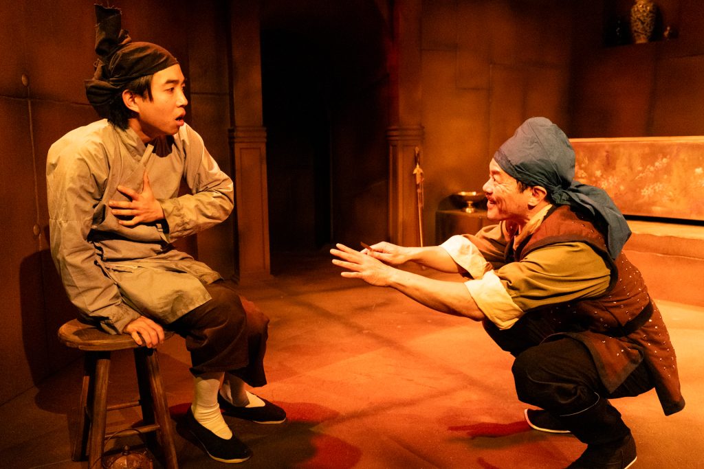 Alt text: Two characters in 17th-century China in In the Tomb of Ten Thousand Calendars at Moving Arts Theatre.