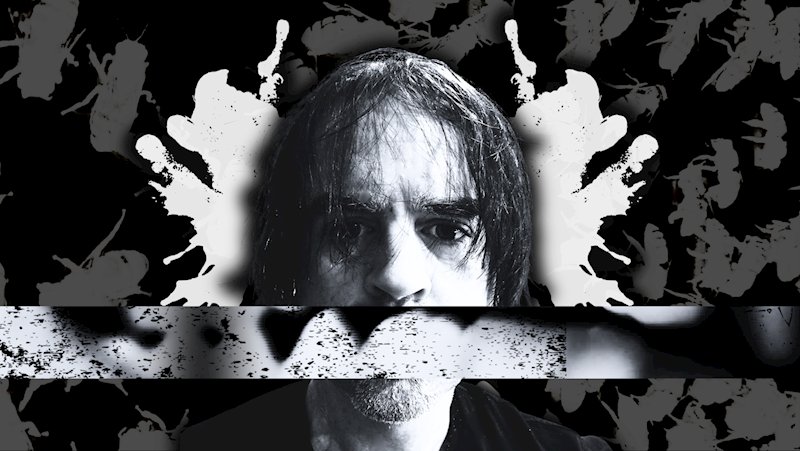 Black-and-white experimental portrait of Stephen James Moore with graphic distortion across his face.