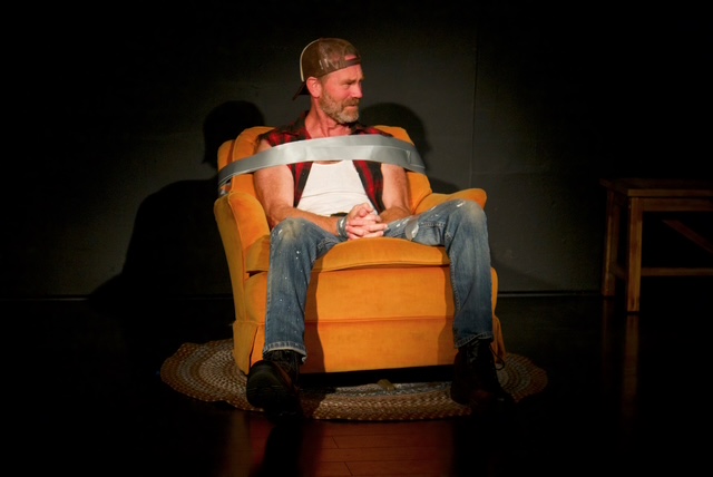 A man is duct-taped to a recliner during Exit, Pursued by a Bear at RD Studio Theatre in North Hollywood.