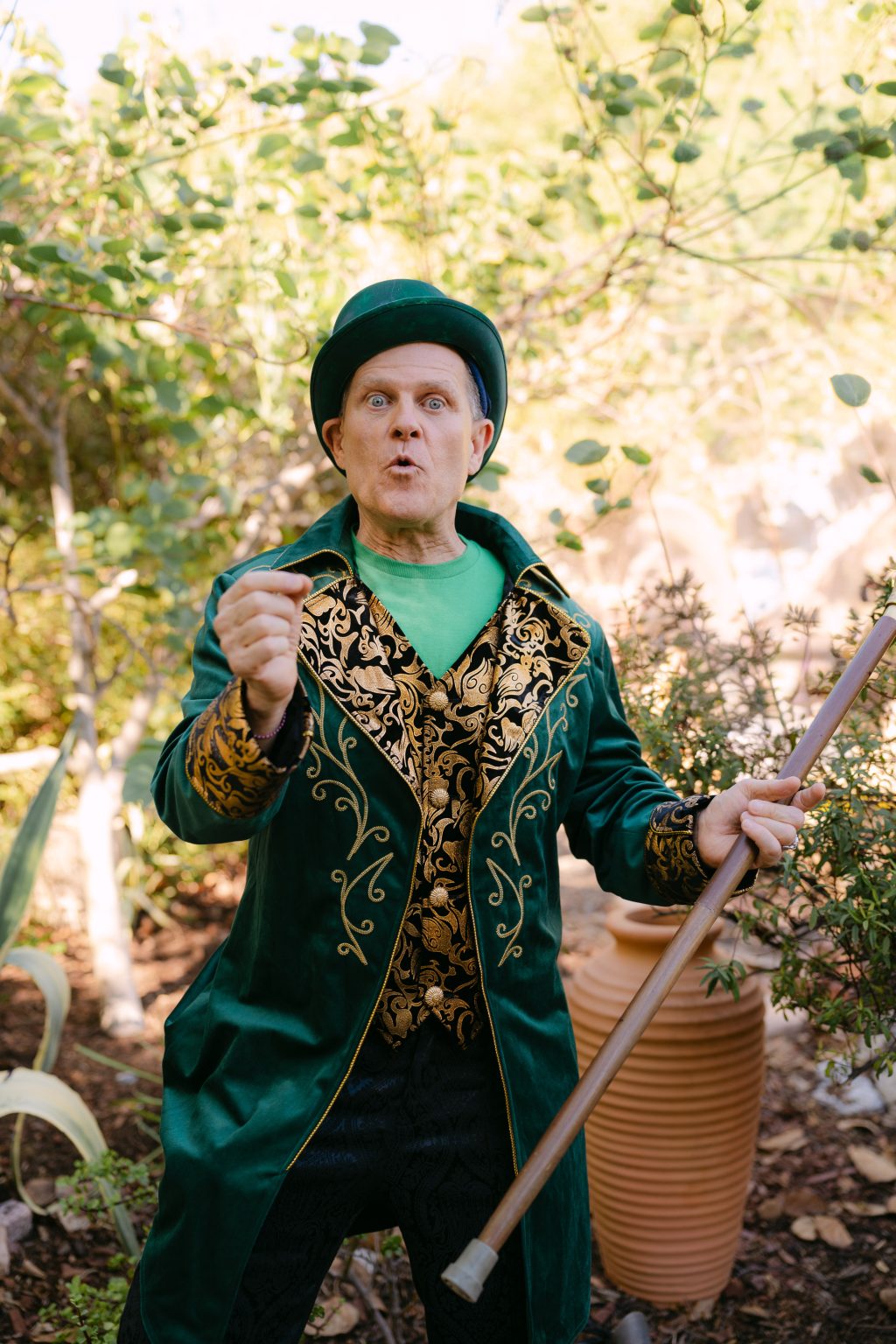 A smiling magical character in a sparkling pink gown and crown performs outdoors in Fall Into Oz.