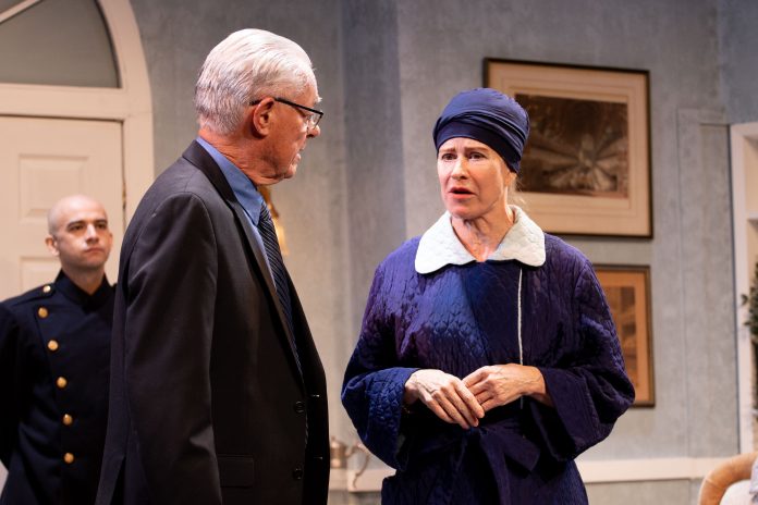 A detective questions a woman in a headscarf during The Group Rep’s Spider’s Web at the Lonny Chapman Theatre.
