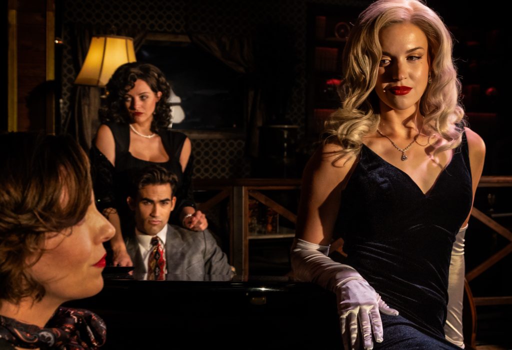 Cast members from A Killer Night in Studio City pose in a dramatic 1950s-style scene at Vitello’s during the immersive murder mystery production.