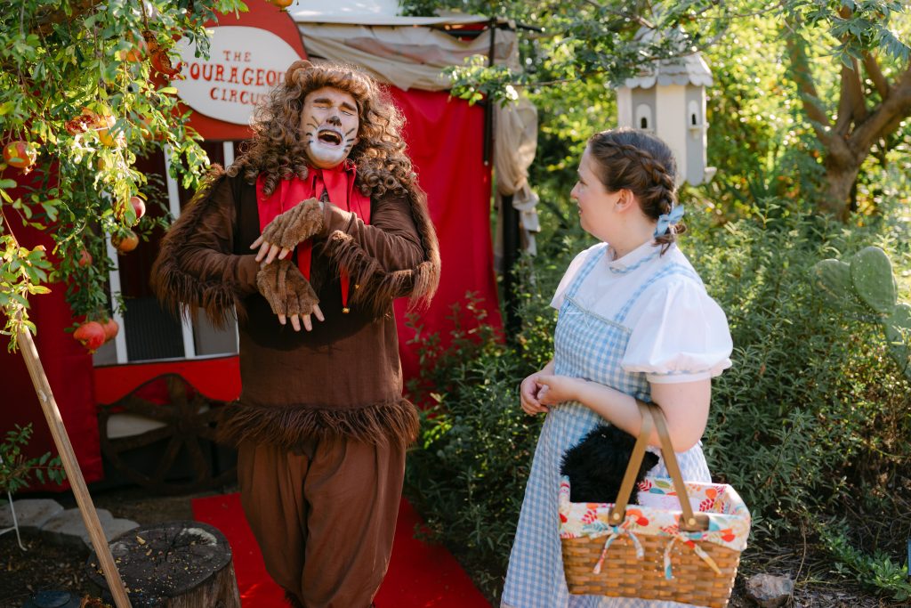 Dayton Axle and Isabella Thatcher perform as the Cowardly Lion and Dorothy in Fall Into Oz.