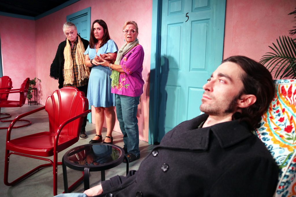 Three women react with concern as a man reclines in the foreground during MOTEL 66 at The Group Rep.