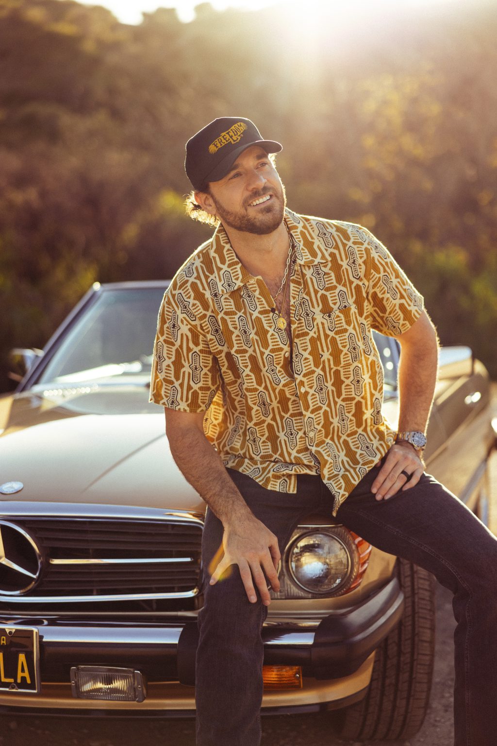 RustRiders singer and Army veteran Ryan Curtis poses beside a vintage Mercedes-Benz convertible in Los Angeles.