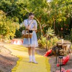 Sabrina Ebright as Dorothy stands on the yellow brick road with a basket during Fall Into Oz in Woodland Hills.