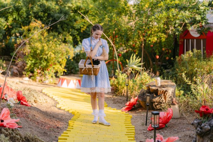Sabrina Ebright as Dorothy stands on the yellow brick road with a basket during Fall Into Oz in Woodland Hills.