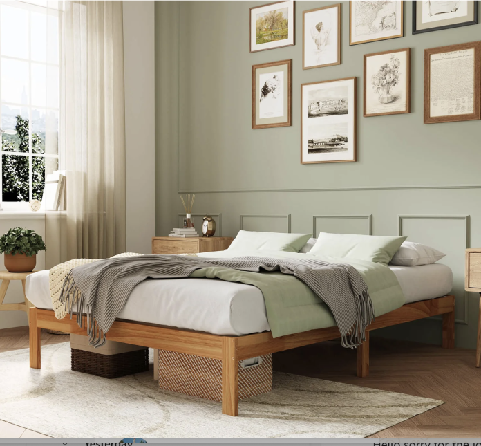 Screenshot 2026-10-28 at 6.18.14 PM Natural wood platform bed frame with white and sage green bedding, matching bedside tables, a gallery wall and warm natural lighting in a cozy bedroom.