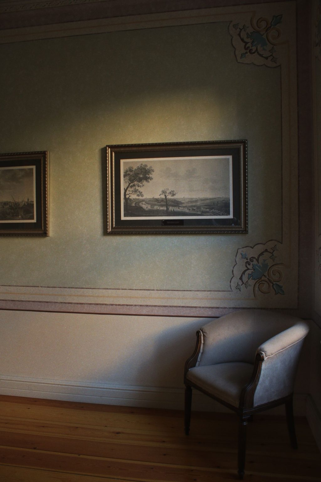 Collection of framed paintings and original artwork displayed on a gallery wall, illustrating art inventory and provenance documentation.