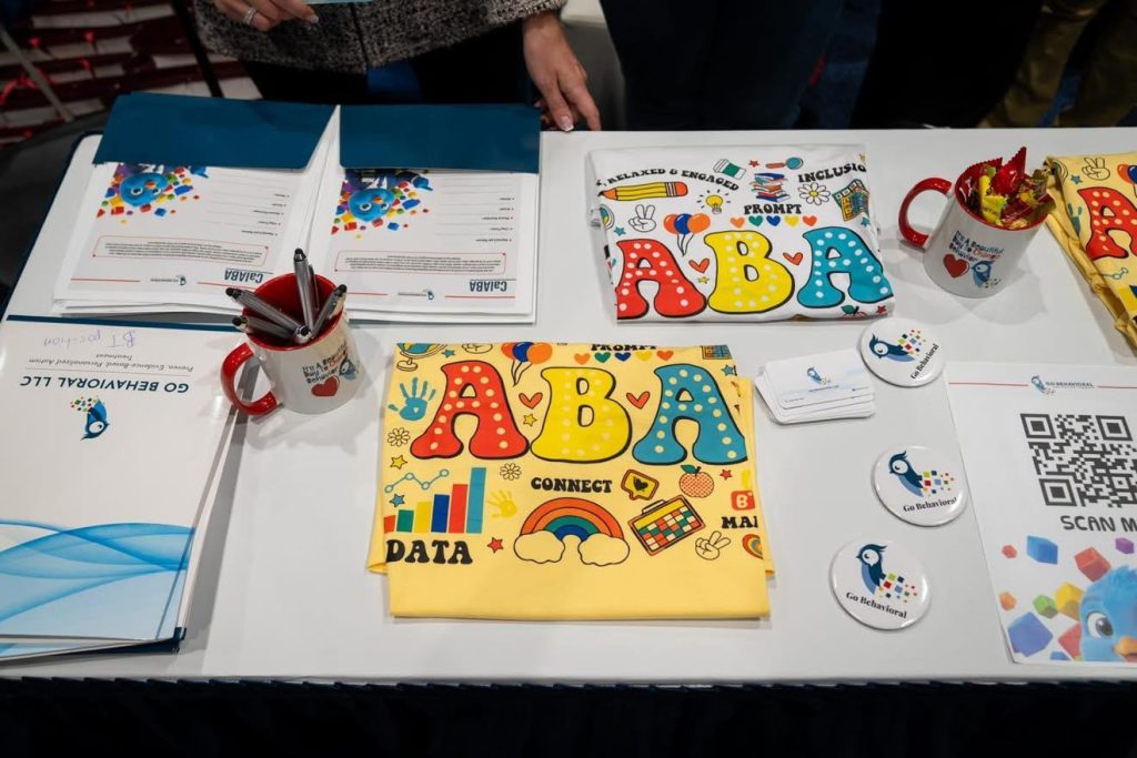ABA therapy educational materials displayed on a table, including activity books, learning resources and informational brochures.