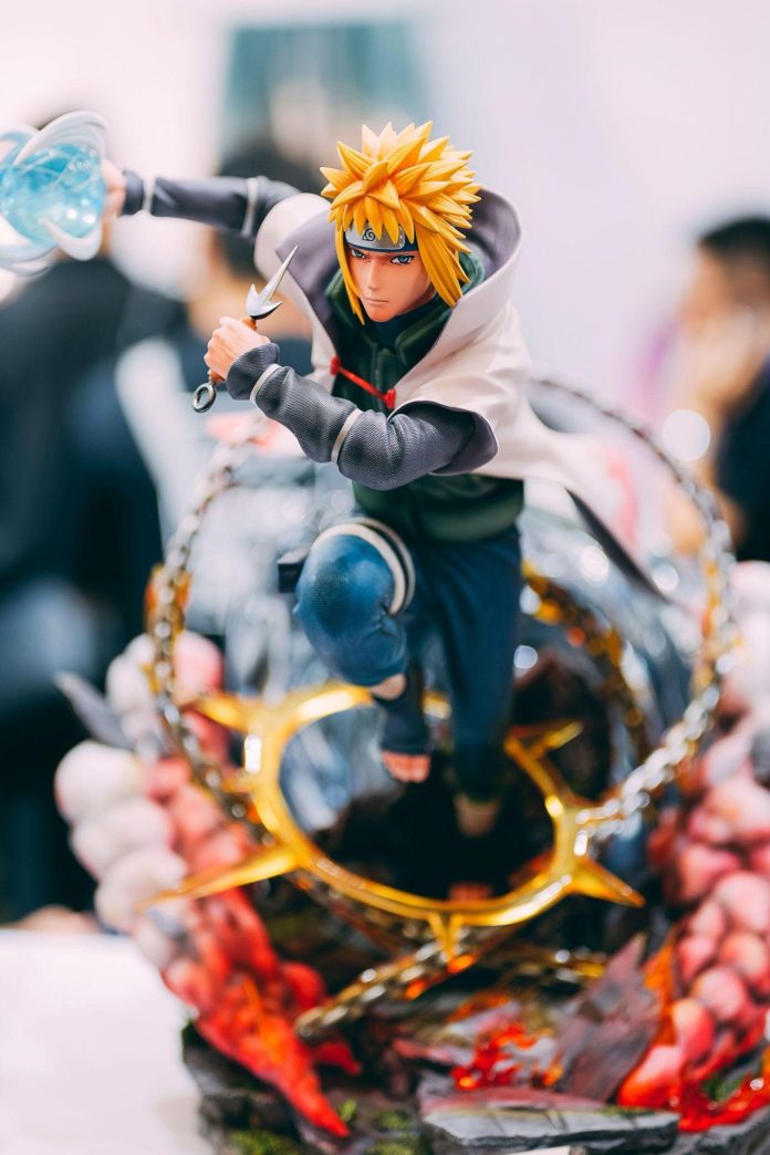 image Minato Namikaze anime figure with spiky yellow hair, holding a kunai and preparing to attack.