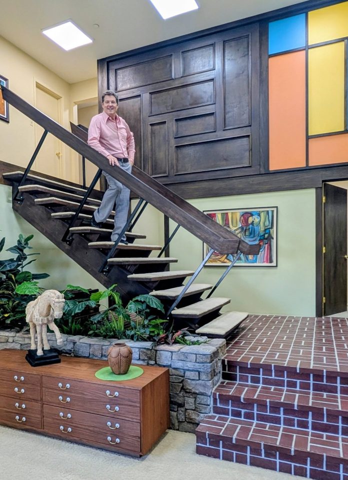 Jack Witt stands on the iconic floating staircase inside The Brady Bunch house in Studio City.