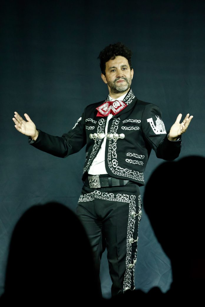 Eduardo Enrikez addresses the audience in traditional mariachi attire during The Last Song at Whitefire Theatre.
